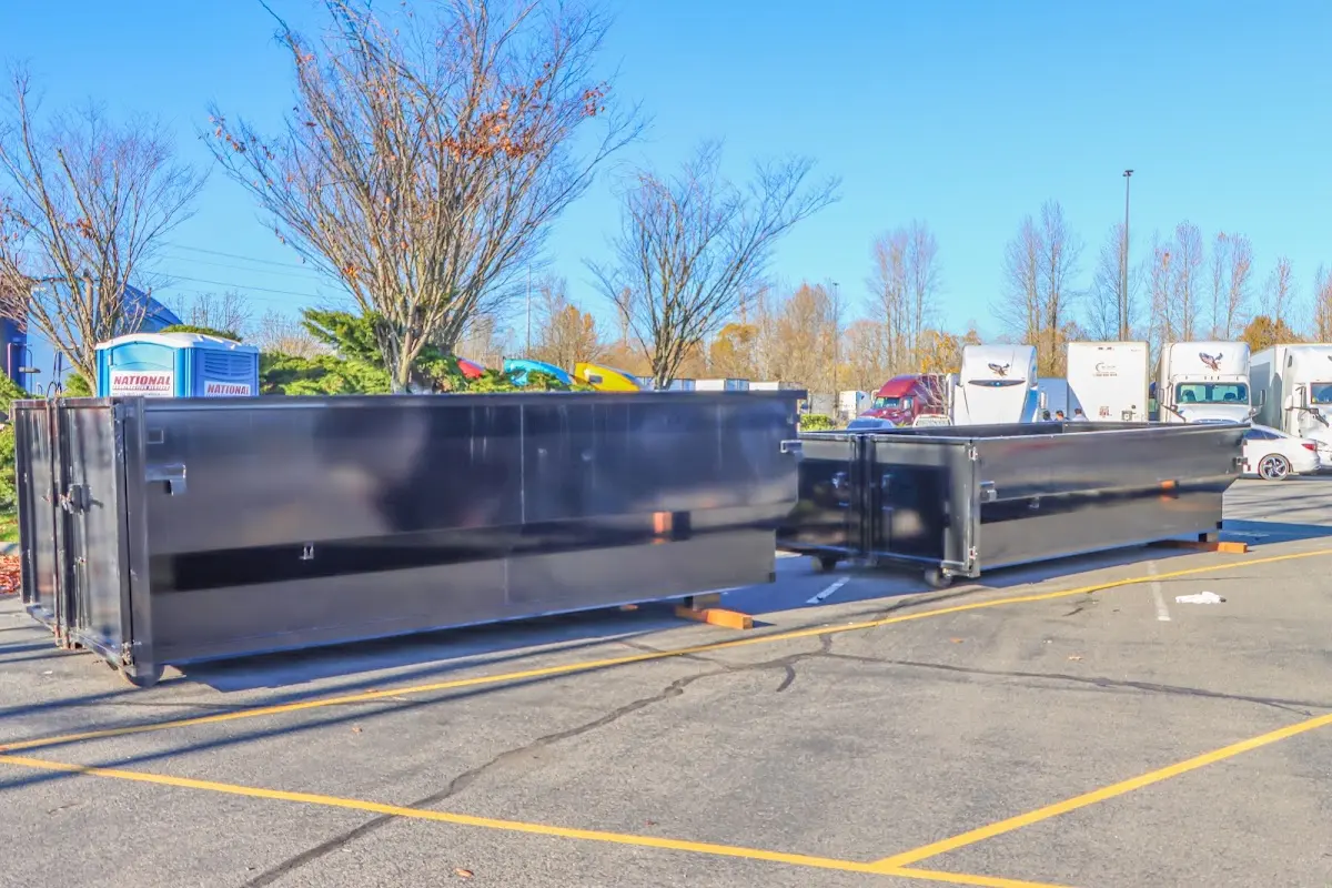 Professional dumpster rental service with roll-off container on residential driveway in Berryville